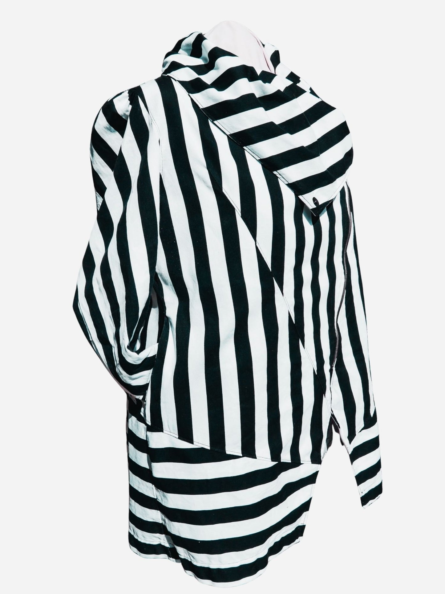 A black and white striped crossover coat/jacket modelled against a lavender background.