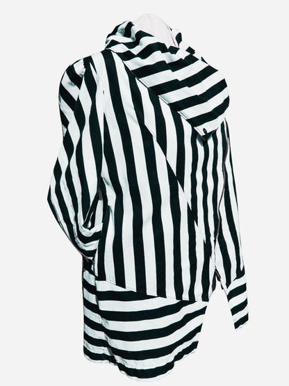 A black and white striped crossover coat/jacket modelled against a lavender background.