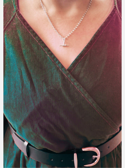 Red dress with a necklace and black belt