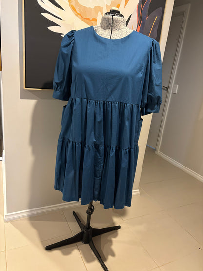 Blue dress on a mannequin against a neutral background
